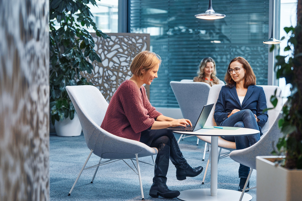 Women talking and working.