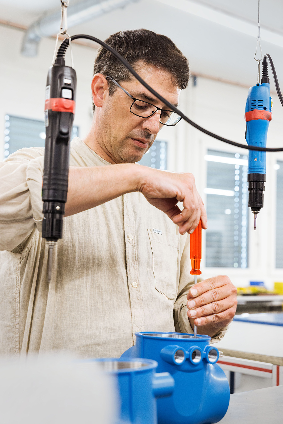 Employee assembles casings.